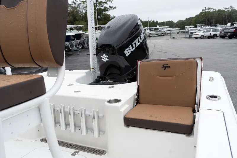 Slide: The Image of 2026 Sea Pro 210 Bay boat with tan and brown seating in a marina setting. - 15