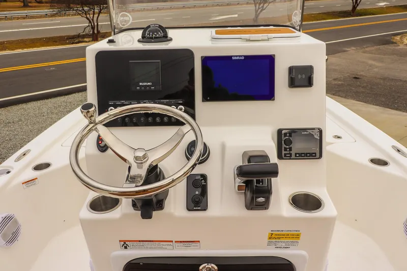 Slide: The Image of 2026 Sea Pro 210 Bay boat console with steering wheel, controls, and navigation display. - 18