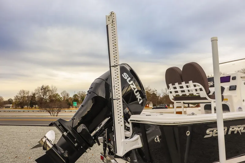 Slide: The Image of 2026 Sea Pro 210 Bay boat with Suzuki outboard motor, parked outdoors. - 19