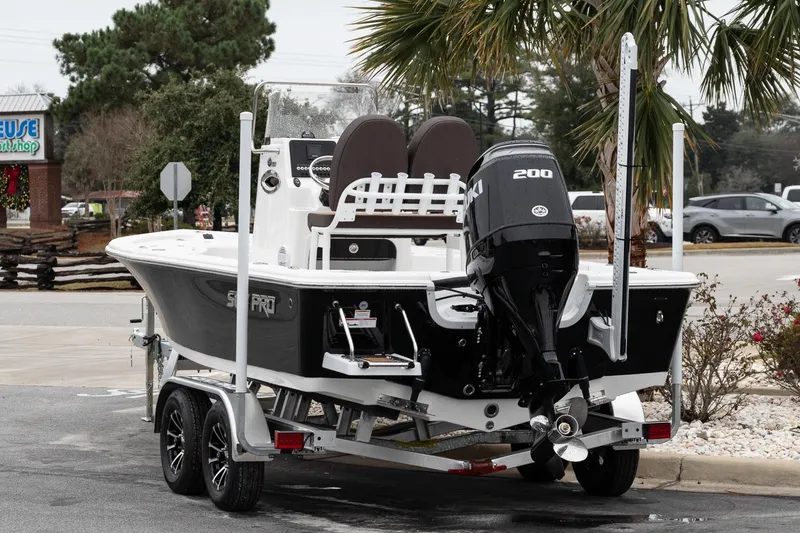 Slide: The Image of 2026 Sea Pro 210 Bay boat on trailer, featuring Suzuki outboard motor. - 5