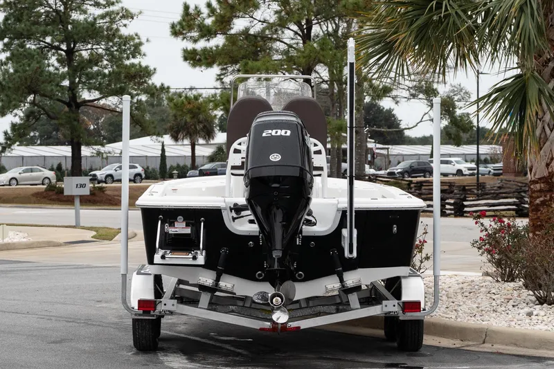 Slide: The Image of 2026 Sea Pro 210 Bay boat on trailer, parked outdoors under cloudy sky. - 6
