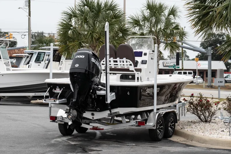 Slide: The Image of 2026 Sea Pro 210 Bay boat on trailer in dealership lot, front view. - 7