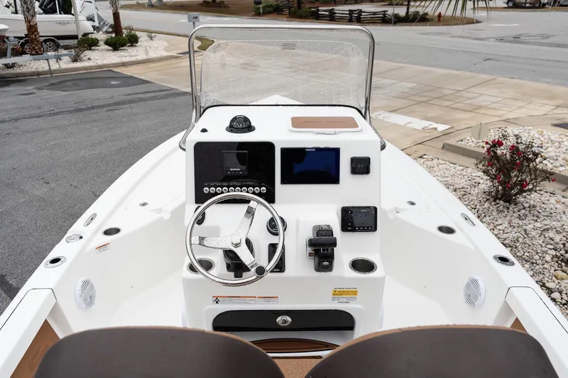 Slide: The Image of 2026 Sea Pro 210 Bay boat, white hull, front view on gravel surface. - 8