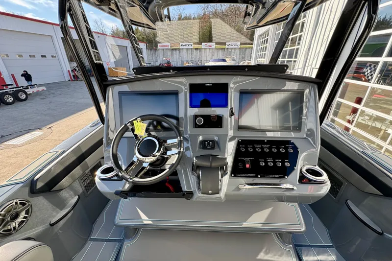 Slide: The Image of 2026 Sunsation 32 CCX boat dashboard with modern controls and dual screens. - 12