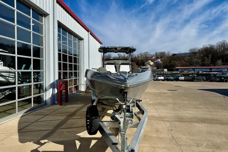 Slide: The Image of 2026 Sunsation 32 CCX boat on trailer outside a modern garage. - 3