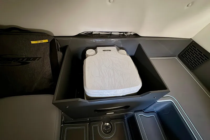 Slide: The Image of 2026 Sunsation 32 CCX interior storage compartment with portable toilet. - 30