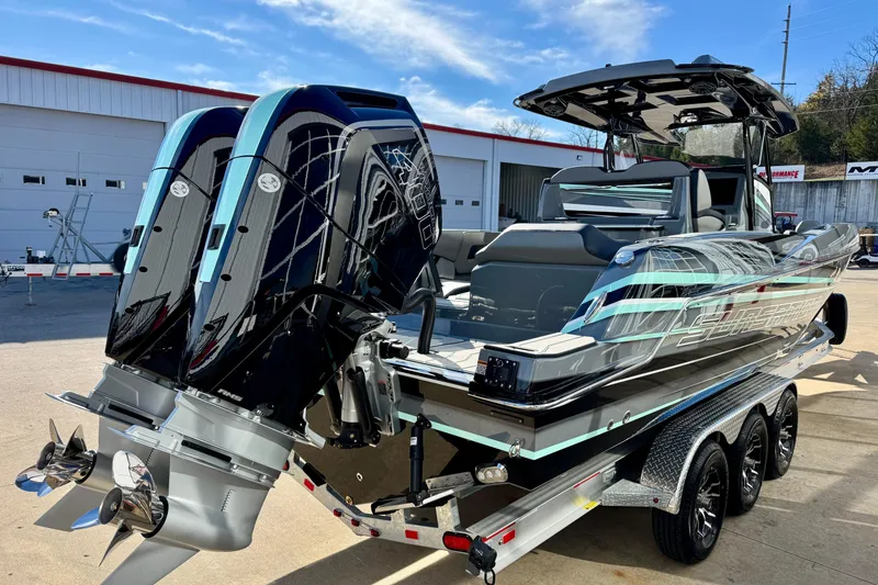 Slide: The Image of 2026 Sunsation 32 CCX boat with dual engines on a trailer, under a clear sky. - 5