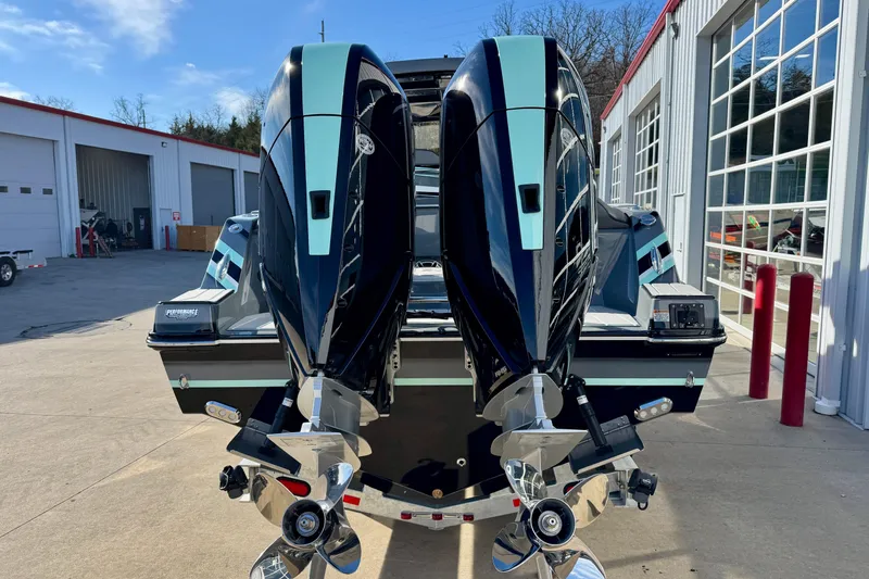 Slide: The Image of 2026 Sunsation 32 CCX boat with dual outboard engines in a marina setting. - 6