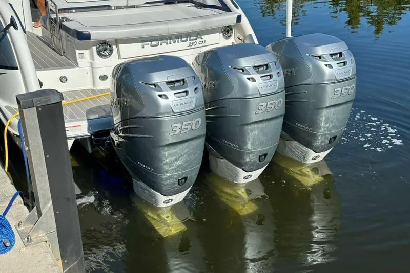 Slide: The Image of 2022 Formula 350 Crossover Bowrider OB with triple Mercury 350 engines docked. - 11