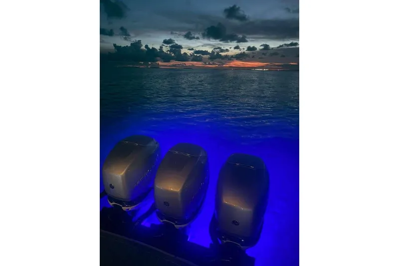 Slide: The Image of 2022 Formula 350 Crossover Bowrider OB engines illuminated at sunset over the ocean. - 16