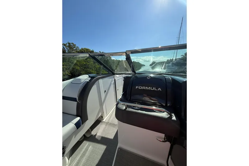 Slide: The Image of 2022 Formula 350 Crossover Bowrider OB interior with clear windshield and sunny view. - 17