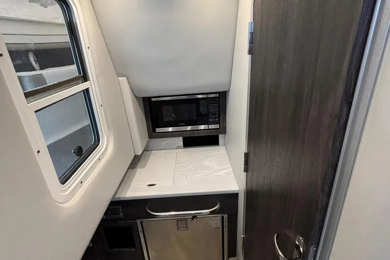 Slide: The Image of Interior of 2022 Formula 350 Crossover Bowrider OB with microwave and compact kitchen area. - 19