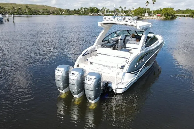 Slide: The Image of 2022 Formula 350 Crossover Bowrider OB with triple outboard engines on calm water. - 2