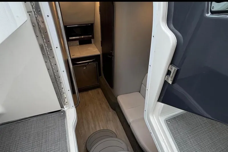 Slide: The Image of Interior view of 2022 Formula 350 Crossover Bowrider OB, featuring compact cabin amenities. - 21