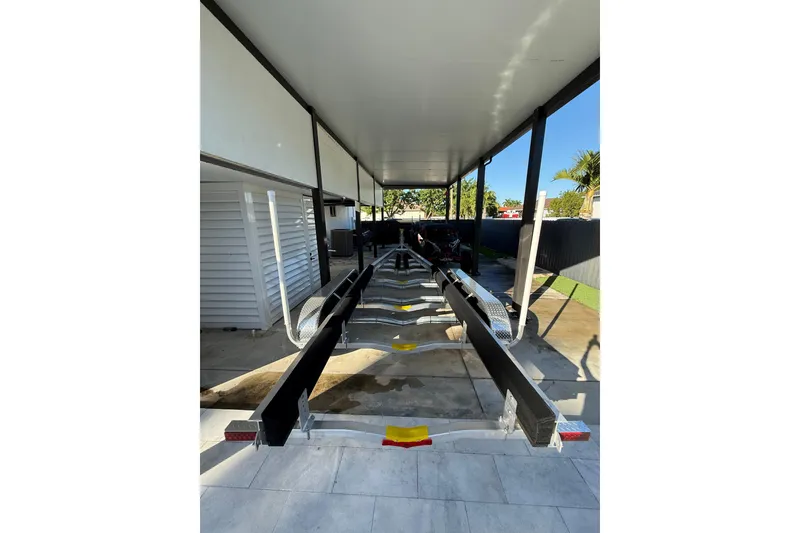 Slide: The Image of Covered storage area for a 2022 Formula 350 Crossover Bowrider OB boat trailer. - 29