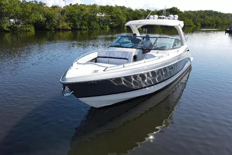 Slide: The Image of 2022 Formula 350 Crossover Bowrider OB on calm water, surrounded by lush greenery. - 5