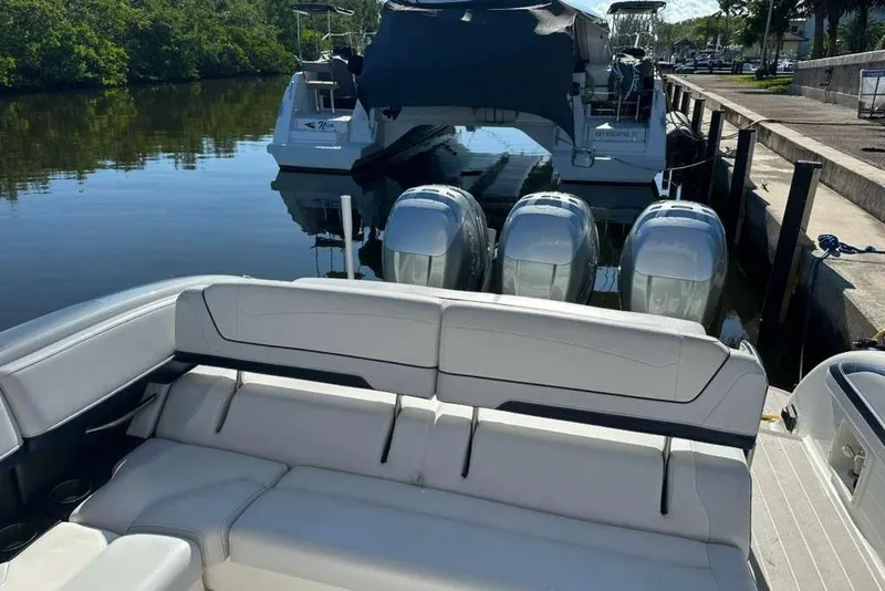Slide: The Image of 2022 Formula 350 Crossover Bowrider OB docked, featuring spacious seating and powerful outboard engines. - 7