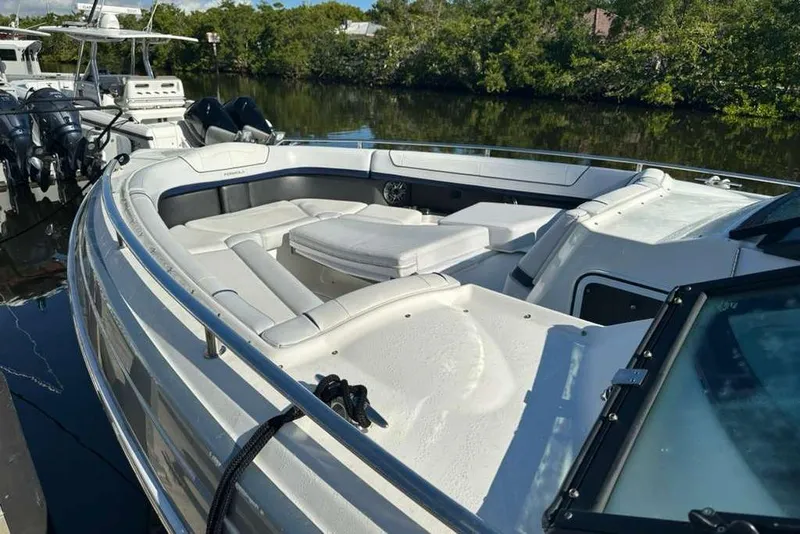 Slide: The Image of 2022 Formula 350 Crossover Bowrider OB docked, featuring spacious seating and sleek design. - 8