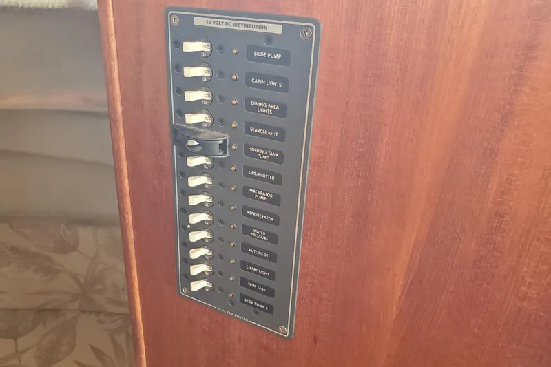 Slide: The Image of Control panel on 2008 Ranger Tugs R-25 boat, featuring various switches and labels. - 16