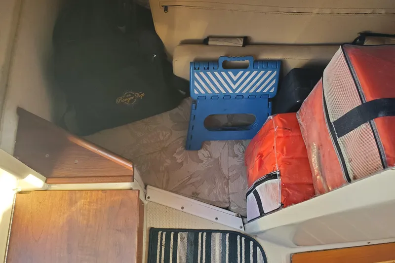 Slide: The Image of Interior of 2008 Ranger Tugs R-25 with storage items and a blue step stool. - 22