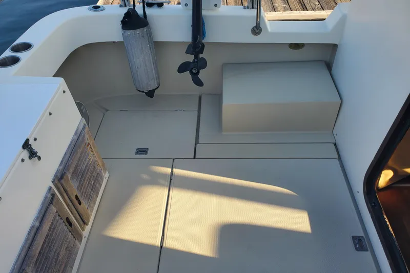 Slide: The Image of 2008 Ranger Tugs R-25 boat deck with storage compartments and dock accessories. - 23
