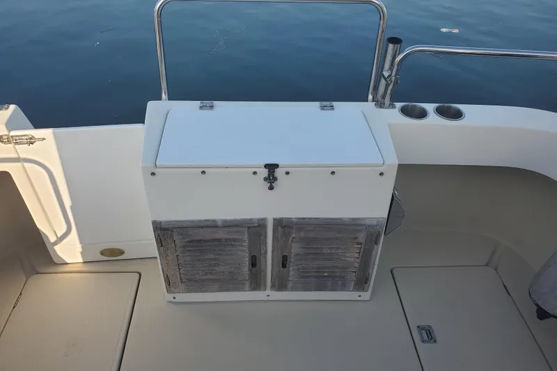 Slide: The Image of 2008 Ranger Tugs R-25 boat deck with storage compartment and cup holders. - 24