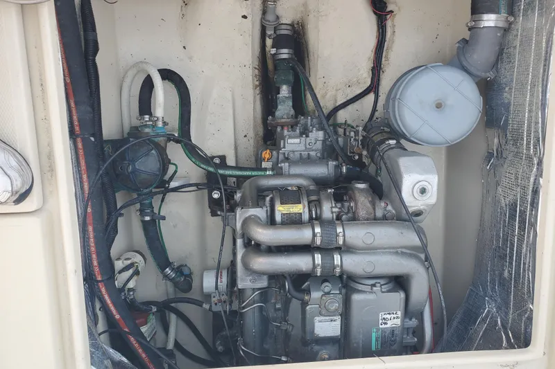 Slide: The Image of Engine compartment of a 2008 Ranger Tugs R-25 boat, showcasing mechanical components. - 27