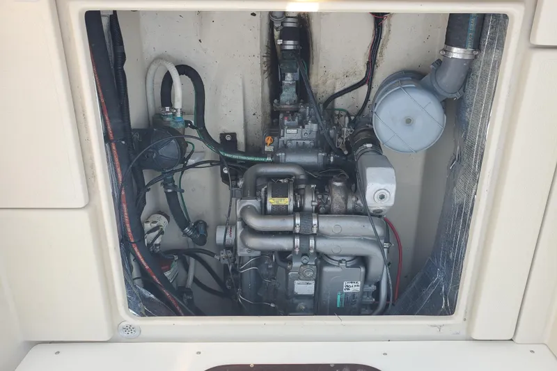 Slide: The Image of Engine compartment of a 2008 Ranger Tugs R-25 boat, showcasing mechanical components. - 28