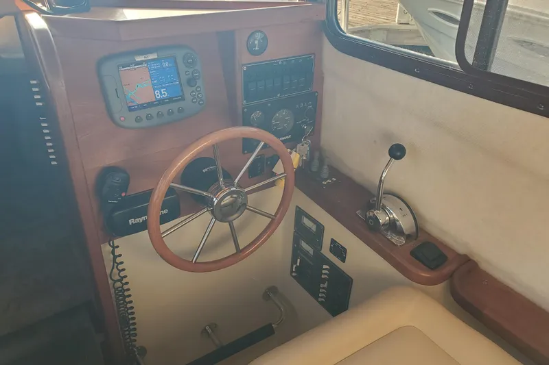 Slide: The Image of 2008 Ranger Tugs R-25 helm with navigation equipment and steering wheel. - 3