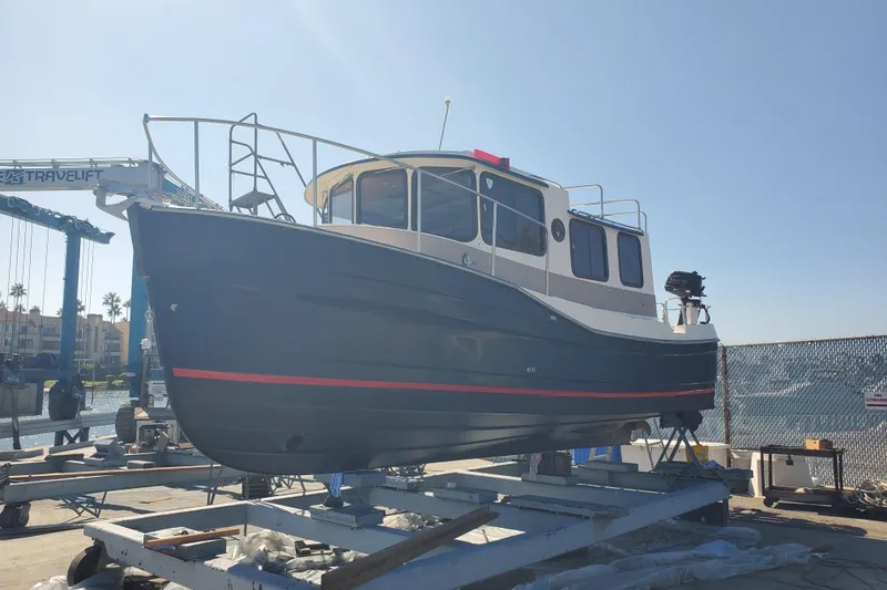 Slide: The Image of 2008 Ranger Tugs R-25 boat on dry dock under clear blue sky. - 30