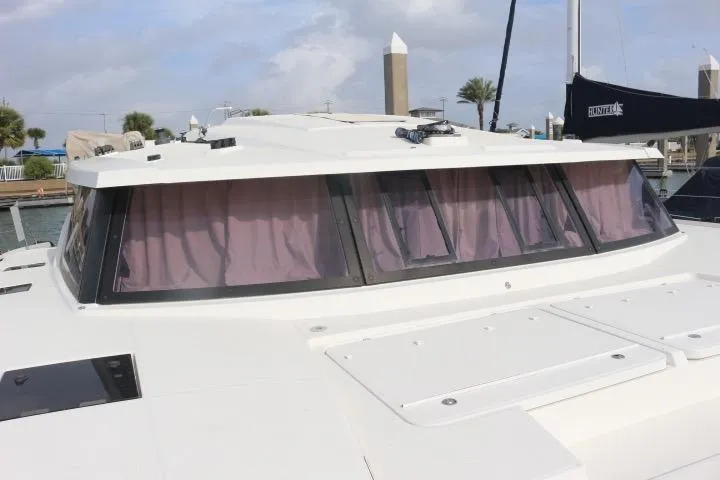 Slide: The Image of 2020 Fountaine Pajot Astrea 42 Catamaran with tinted windows and sleek design. - 10