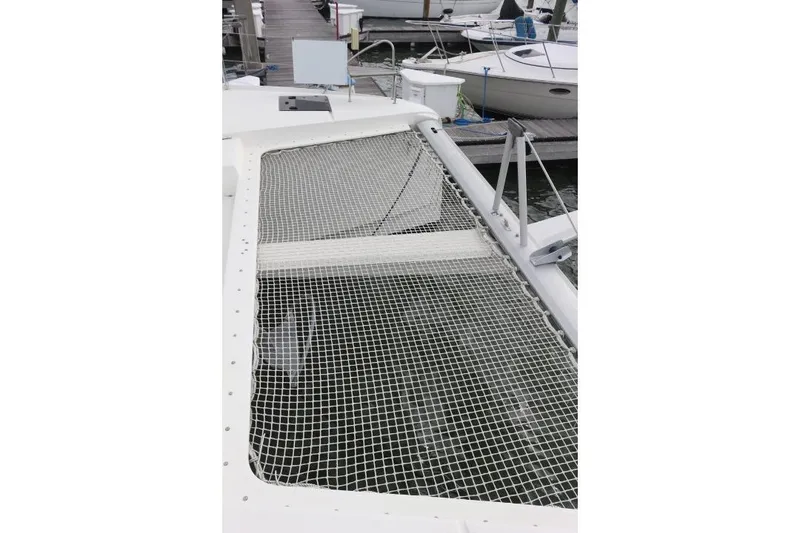 Slide: The Image of 2020 Fountaine Pajot Astrea 42 Catamaran with netted deck, docked at marina. - 11