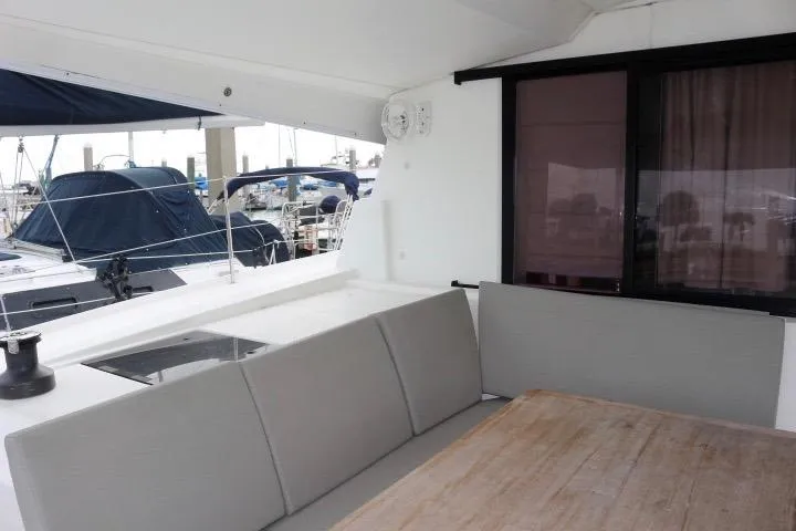 Slide: The Image of 2020 Fountaine Pajot Astrea 42 Catamaran with outdoor seating and marina view. - 13