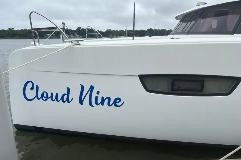 Slide: The Image of 2020 Fountaine Pajot Astrea 42 Catamaran named "Cloud Nine" docked on a calm waterway. - 15