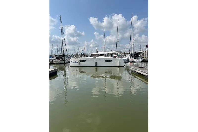Slide: The Image of 2020 Fountaine Pajot Astrea 42 Catamaran docked in a marina under a blue sky. - 17