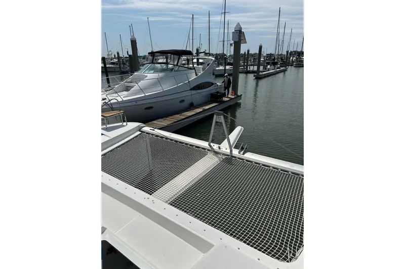 Slide: The Image of 2020 Fountaine Pajot Astrea 42 Catamaran docked at marina with other boats. - 23