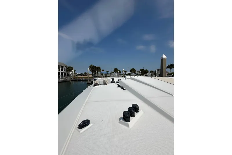 Slide: The Image of 2020 Fountaine Pajot Astrea 42 Catamaran deck view in marina under clear blue sky. - 25