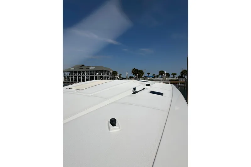 Slide: The Image of 2020 Fountaine Pajot Astrea 42 Catamaran docked at marina under clear blue sky. - 27