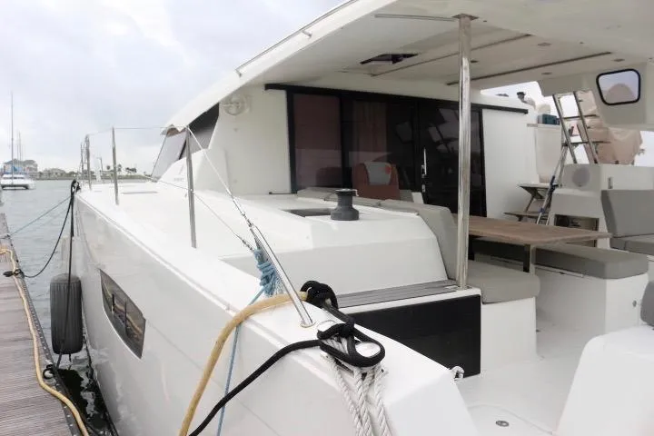 Slide: The Image of 2020 Fountaine Pajot Astrea 42 Catamaran docked, showcasing spacious deck and modern design. - 4