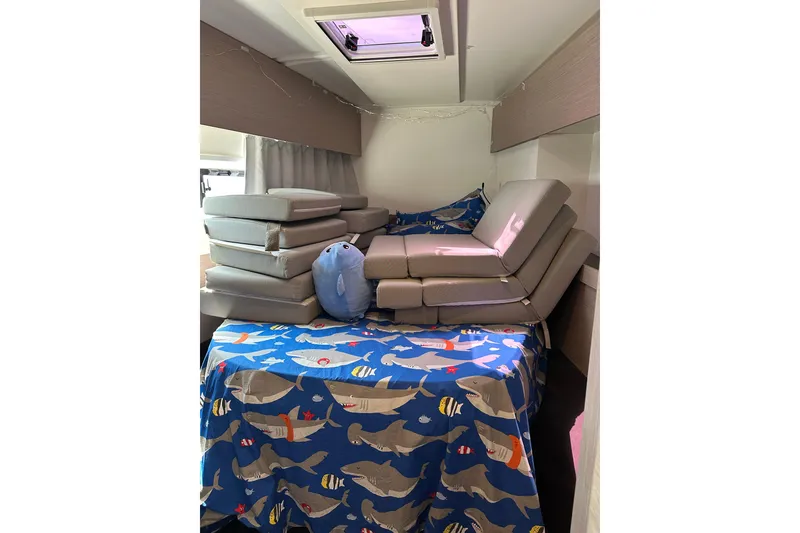 Slide: The Image of Interior of 2020 Fountaine Pajot Astrea 42 Catamaran with stacked cushions and marine-themed decor. - 46