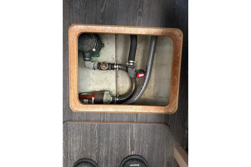 Slide: The Image of Bilge compartment of 2020 Fountaine Pajot Astrea 42 Catamaran with visible pump and hoses. - 49