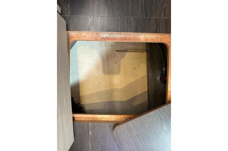 Slide: The Image of Open hatch on 2020 Fountaine Pajot Astrea 42 Catamaran floor, revealing storage compartment. - 50