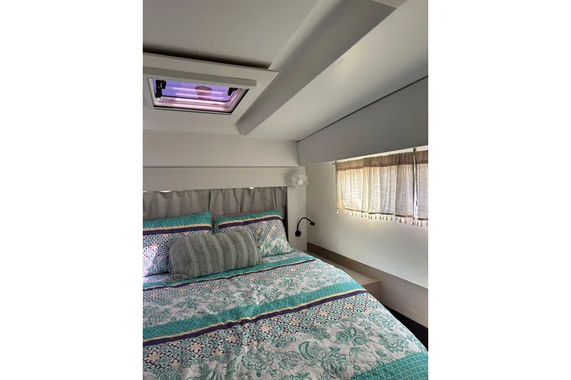 Slide: The Image of Cozy bedroom interior of 2020 Fountaine Pajot Astrea 42 Catamaran with patterned bedding. - 56
