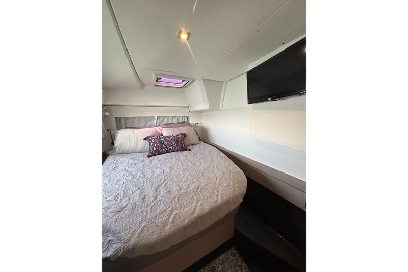 Slide: The Image of Cozy bedroom in 2020 Fountaine Pajot Astrea 42 Catamaran with elegant bedding and TV. - 58