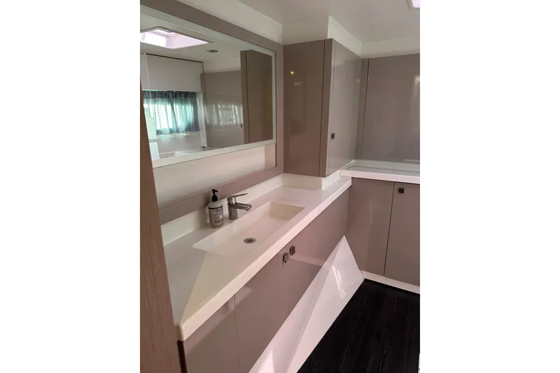 Slide: The Image of Modern bathroom interior on 2020 Fountaine Pajot Astrea 42 Catamaran, featuring sleek cabinetry and sink. - 63