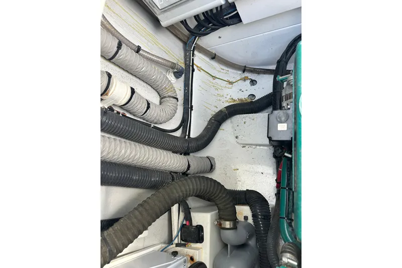 Slide: The Image of Engine compartment of 2020 Fountaine Pajot Astrea 42 Catamaran with visible hoses and wiring. - 77