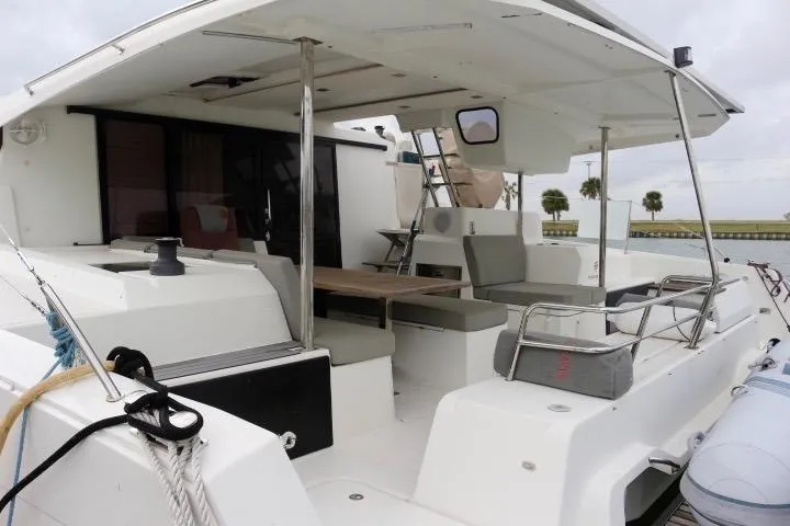 Slide: The Image of 2020 Fountaine Pajot Astrea 42 Catamaran, spacious deck with seating and table. - 8