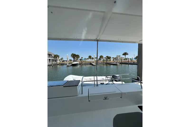 Slide: The Image of 2020 Fountaine Pajot Astrea 42 Catamaran docked at a scenic marina with palm trees. - 80