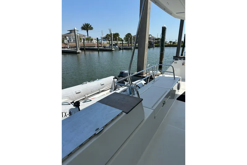 Slide: The Image of 2020 Fountaine Pajot Astrea 42 Catamaran docked at marina with inflatable boat. - 81