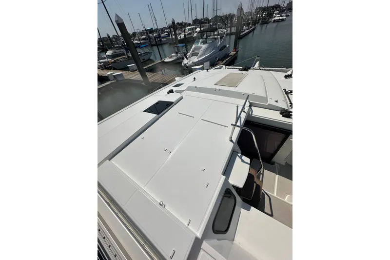 Slide: The Image of 2020 Fountaine Pajot Astrea 42 Catamaran docked at marina, showcasing sleek deck design. - 82